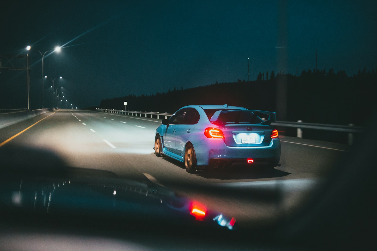 white sedan on road during night time