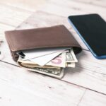 black leather bifold wallet on white table